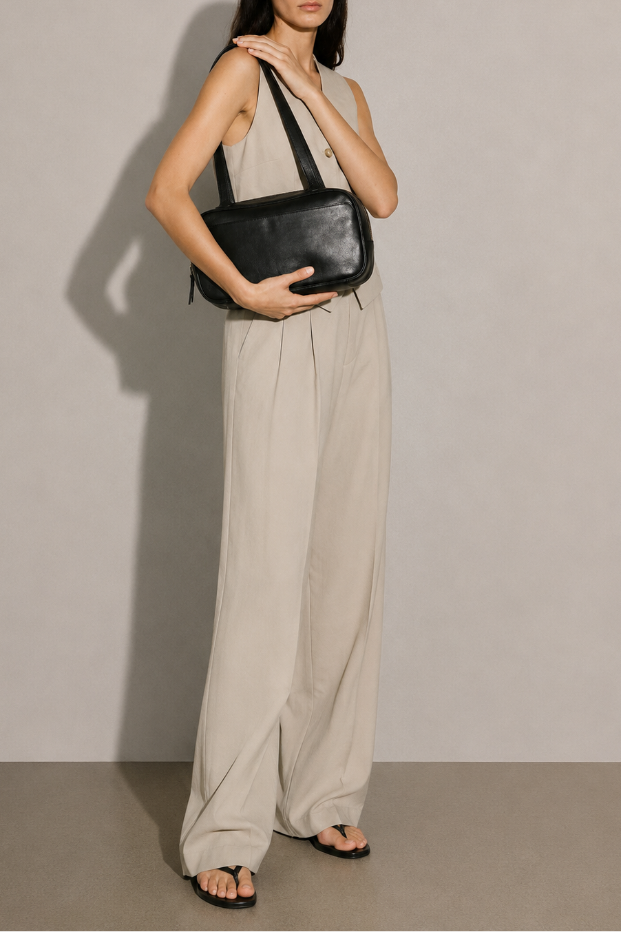 Leather Bowler bag in black full grain leather. Has two shoulder straps and many interior pockets. It also has an outside pocket for a smartphone. 