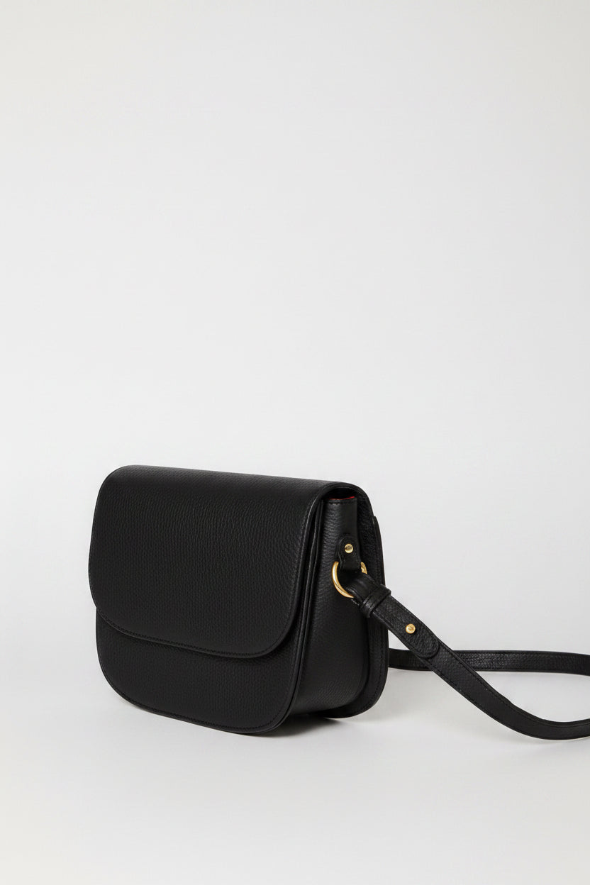 Handcrafted leather saddle bag with shoulder strap and gold hardware. Simple clean design. 