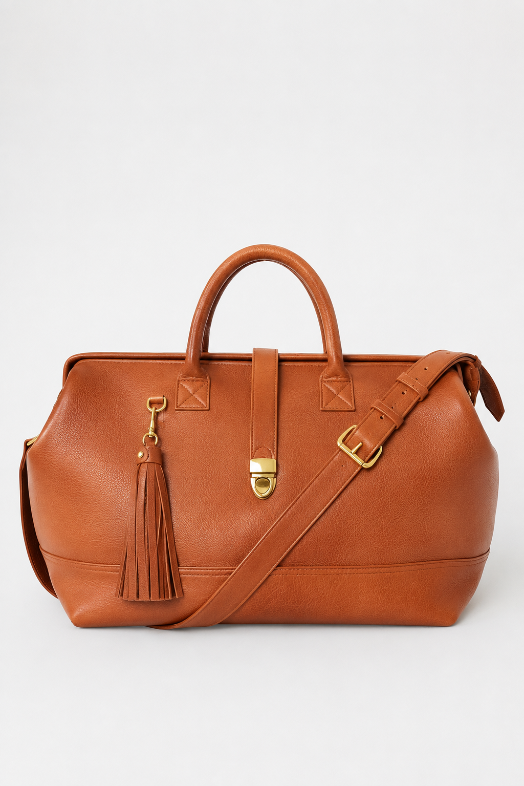 Doctor weekender Duffle handcrafted in full gain leather with a metal frame closure. Gold hardware, brass feet and top handle. 