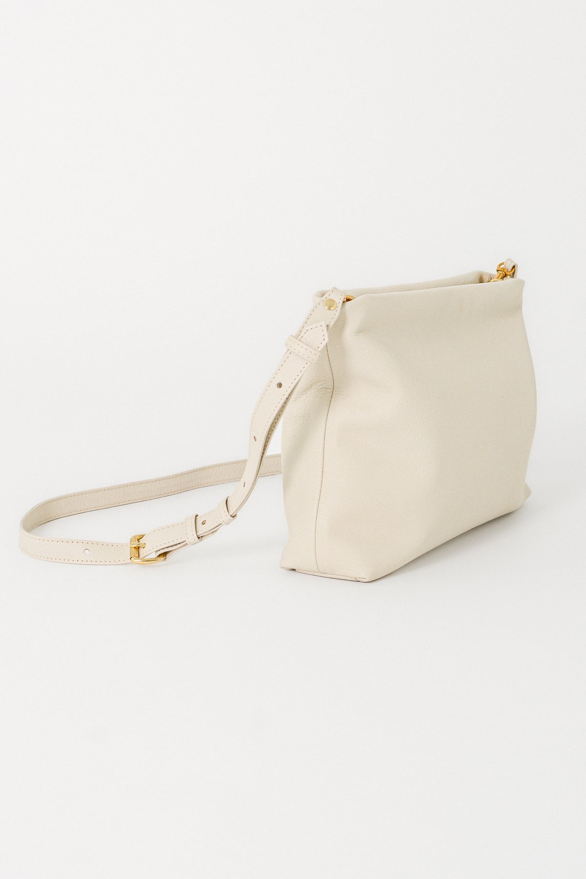 off-white handbag with a strap on a white background