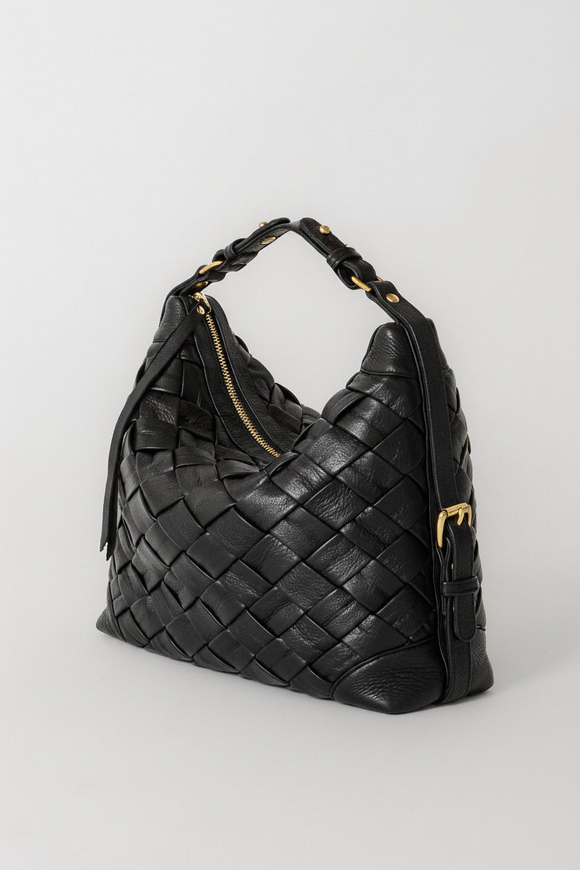 Black Selena Handwoven leather bag shown with the shorter shoulder strap, highlighting the woven construction, structured silhouette, and gold hardware details.